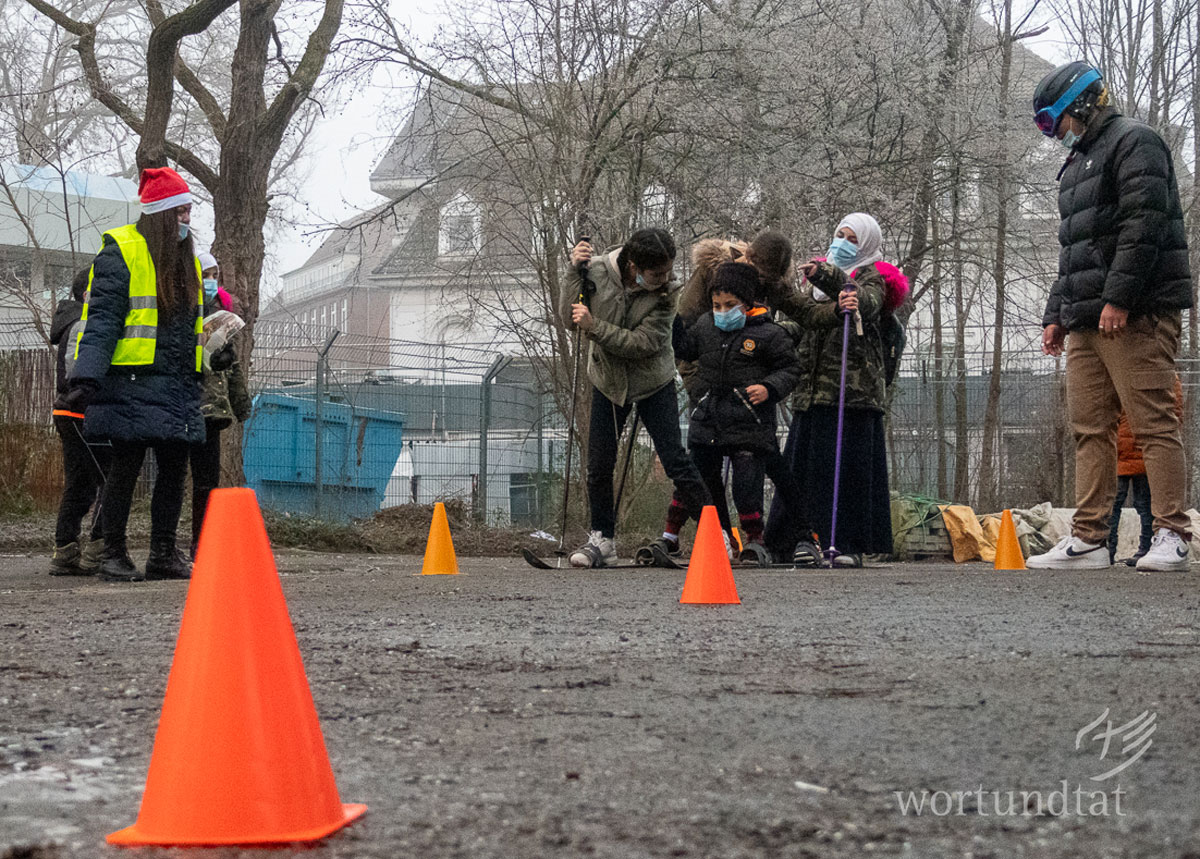 In 2021, Achraf is still volunteering at Stern - here at the Christmas party dressed as a skier (right). Children trying to walk together with one pair of skies fixed at their feet