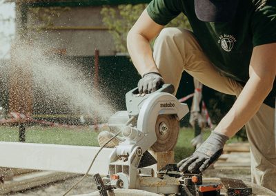 Man sawing beams with a crosscut saw