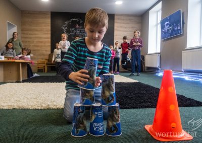 Boy builds tower from upside down cups