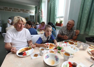 Visitors in soup kitchen eat lunch