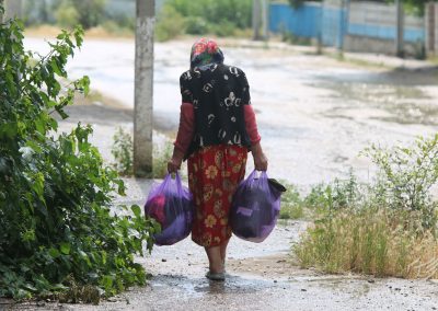 Woman with bags full of secondhand clothes on the way home