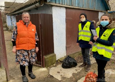 Senior woman and two young people bringing her groceries